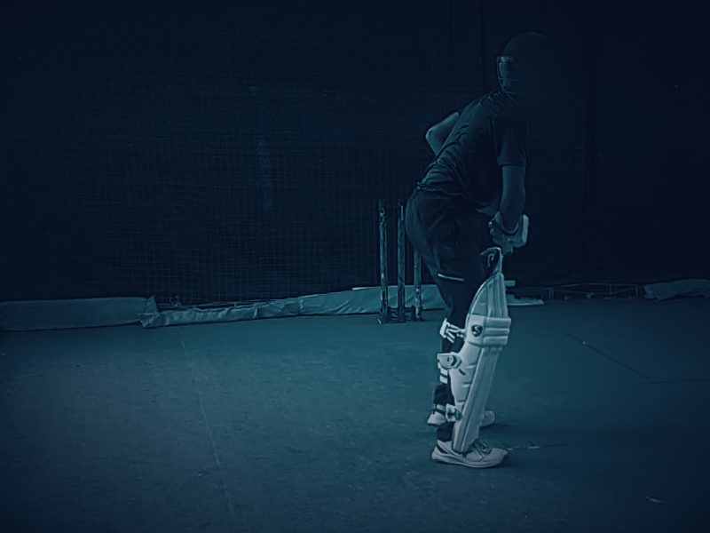 Left-hand batter in a practice net, identity masked, with SWPI body-landmark tracking drawn over the frame